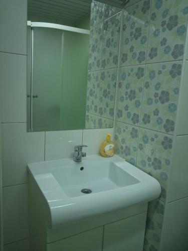 a bathroom with a white sink and a mirror at STRUNA in Ohrid