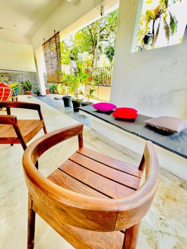 a wooden chair in a living room with a table at Kumudu Holiday Home in Hiriketiya