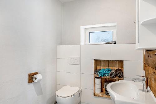 a bathroom with a toilet and a sink at Auszeit Helsa in Helsa