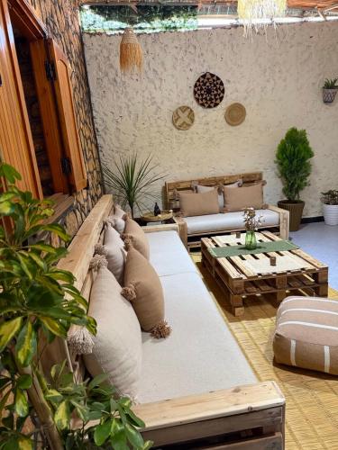 a living room with a couch and a table at 5 Min to Beach & Calm Villa Retreat in Safi