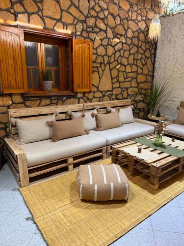 a living room with two couches and a coffee table at 5 Min to Beach & Calm Villa Retreat in Safi