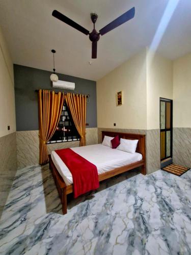 a bedroom with a large bed and a window at Town Tulip in Karativu