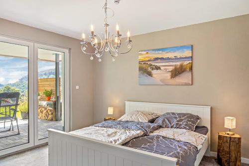 a bedroom with a bed and a chandelier at Auszeit Helsa in Helsa