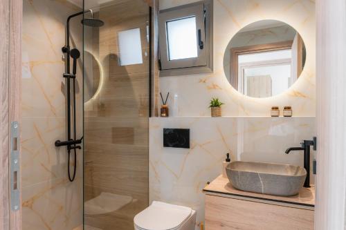 a bathroom with a shower with a sink and a toilet at Villa Esperia in Áyios Síllas