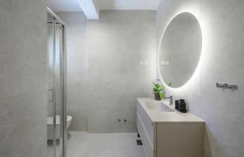 a bathroom with a sink and a mirror at Villa Botanica near Split - Heated Pool and Garden in Kučine