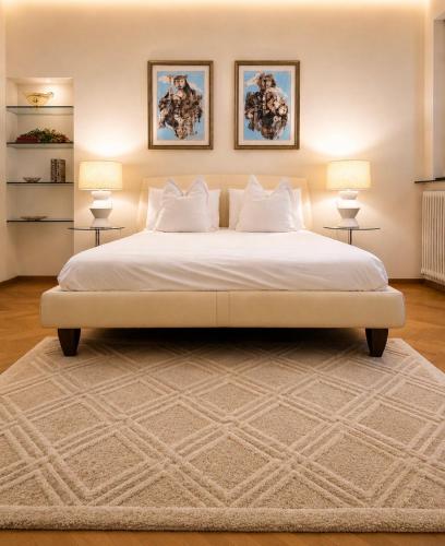 a bedroom with a large bed with two lamps at ComeCasa No ZTL Alfieri Urban Stay in Asti
