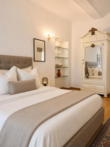 a bedroom with a large bed with a large mirror at ComeCasa No ZTL Alfieri Urban Stay in Asti