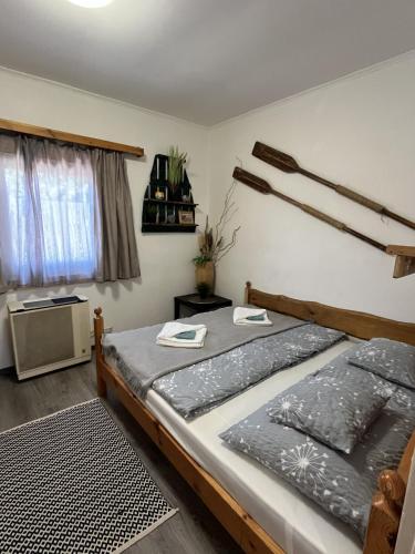 a bedroom with two beds and a window at Amur Vendégház in Gárdony