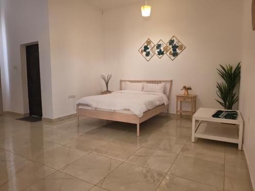 a bedroom with a bed and a table on a tile floor at Moonlight Resort in Sinādil