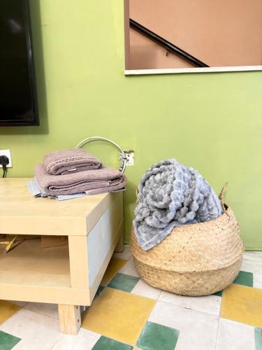 a basket sitting on a table next to a television at Arantza House in Sliema