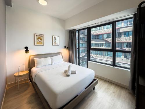 a bedroom with a bed and a large window at Arte Plus Jalan Ampang by Airhost in Kuala Lumpur