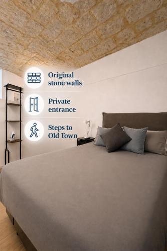 a bedroom with a large bed with words on the wall at Bari LandLord 31- Old Town Apartment in Bari