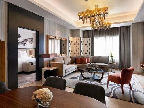 a living room with a couch and a table at Pullman Jakarta Indonesia in Jakarta