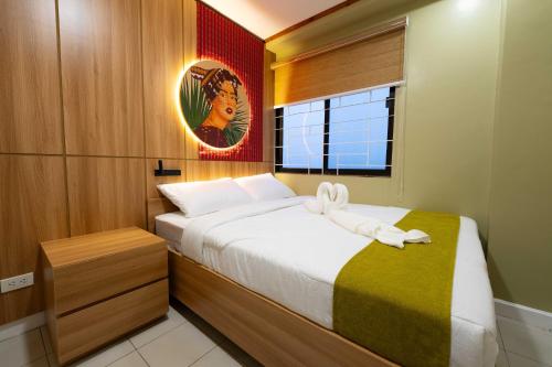 a bedroom with a bed with a stuffed animal on it at Highland Nest in Baguio