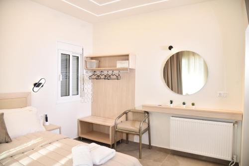 a bedroom with a bed and a sink and a mirror at Villa Kostas Sarti in Sarti
