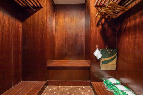 a walk in shower with wood paneling and a towel at Formosan Naruwan Hotel in Taitung City