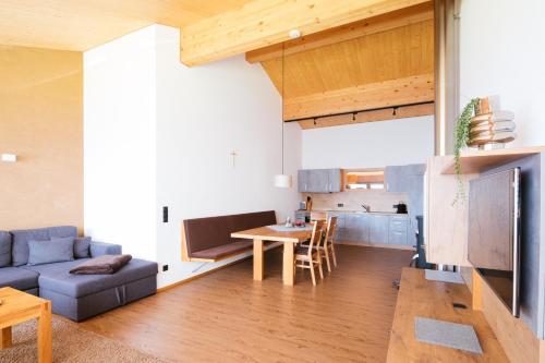 a living room with a couch and a table at Alpenpanorama Konzett Faschina in Fontanella