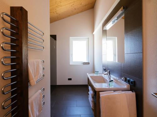 a bathroom with a sink and a mirror at Alpenpanorama Konzett Faschina in Fontanella