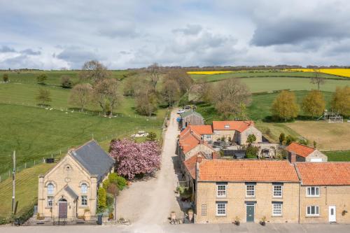 an aerial view of a house and a road at Jasmine Cottage - Sands Farm in Wilton