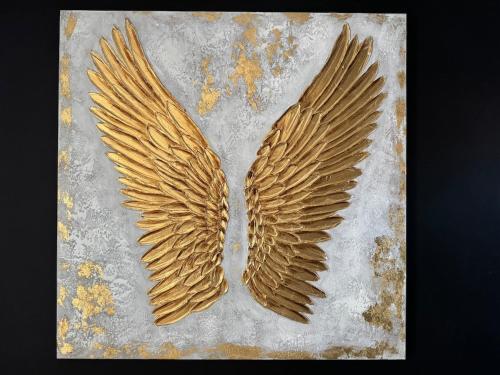a pair of gold wings on a concrete slab at ღ L'Urban Gare - T3 Cosy Parking & Wifi in Douai