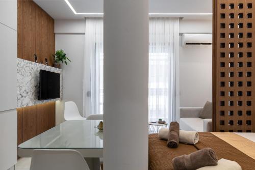 a kitchen and living room with a glass table at Elite Suite in Xanthi