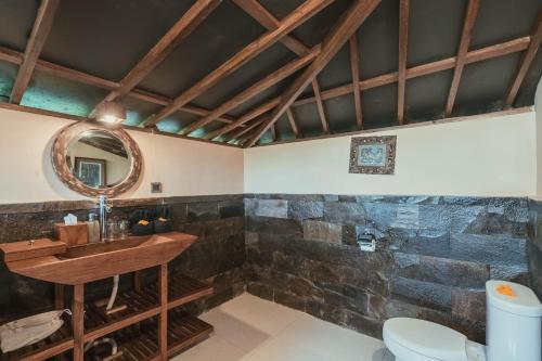 a bathroom with a sink and a toilet at Alassari Sanctuary in Selemadeg
