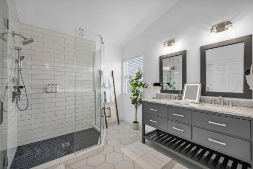 a bathroom with a shower and a sink and a mirror at Vegas Haven Pool Spa Game Room in Las Vegas