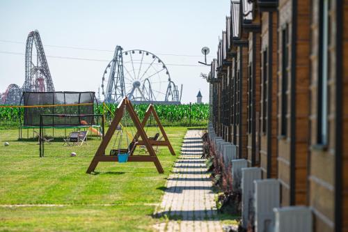 a playground with a roller coaster in a park at DOMKI#ENERGY Zator in Przeciszów