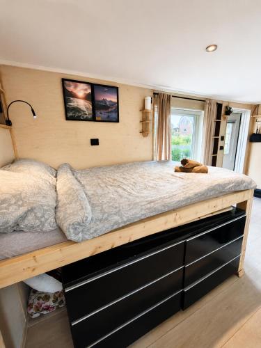 a bedroom with a large bed in a room at Tiny House - The LOWFO House Lofoten in Moskenes