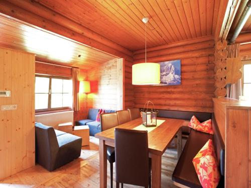 a dining room with a table and a couch at Chalet in the Wilder Kaiser ski area in Tyrol in Wörgl