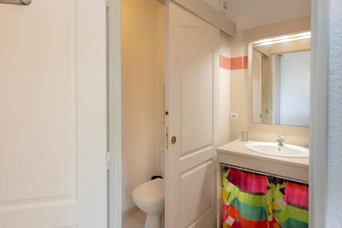 a bathroom with a sink and a toilet and a mirror at Studio Le Splendid 3 Hôtel étoiles in Allevard