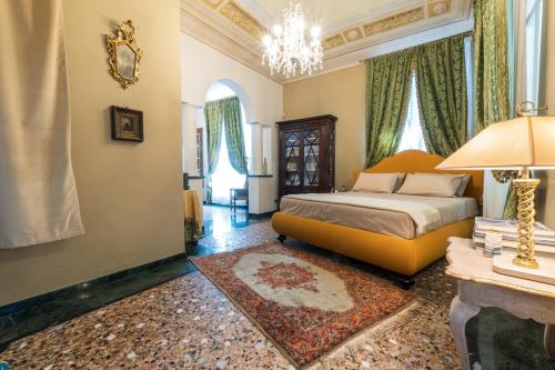 a bedroom with a king sized bed and a chandelier at Villa Messori Spa in Castelvetro di Modena