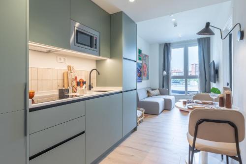 a kitchen and living room with a couch at Be Casa Barakaldo in Barakaldo