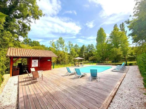 a wooden deck with a pool and a gazebo at Les bouleaux in Cussac