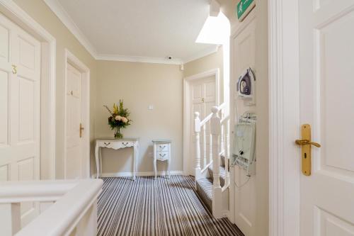a hallway with a white door and a table at Almara Guesthouse in Galway