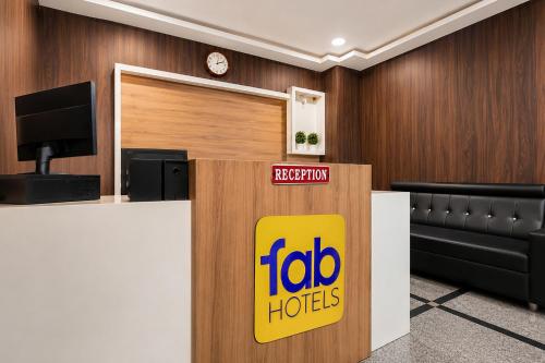 a fedex office with a sign on a reception desk at FabHotel Anu Grand - Vijayawada in Vijayawāda
