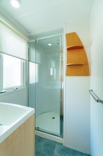 a bathroom with a shower and a glass shower backdoor at Camping Tucan - Mobile Homes by Lifestyle Holidays in Lloret de Mar