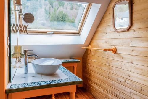 a bathroom with a sink and a window at Mirabeau in Le Mont-Dore