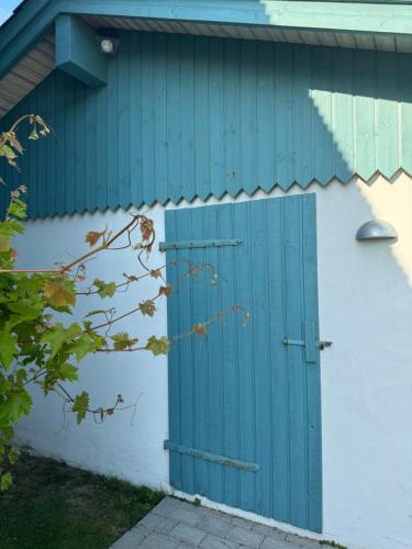 a blue door on the side of a building at Tiny Guesthouse in Nakskov