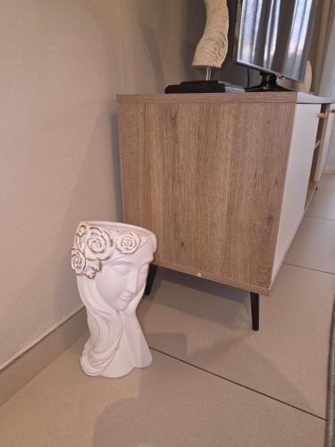 a white toilet sitting next to a wooden cabinet at Classy and Cosy 5 in Fourways
