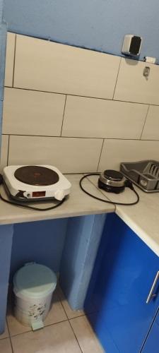 a shelf with a toaster and a phone on it at Ioannis House Apartment in Asprovalta