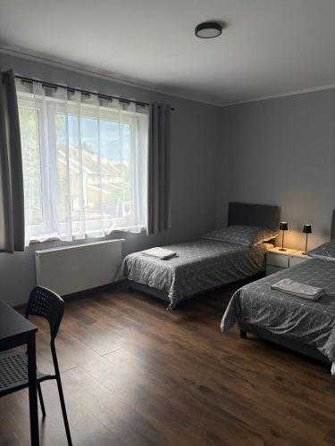 a bedroom with two beds and a window at Horiza in Gdańsk