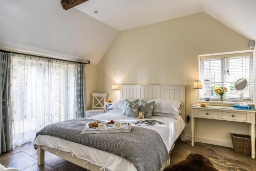 a bedroom with a bed with a tray of food on it at Downclose Piggeries in North Perrott