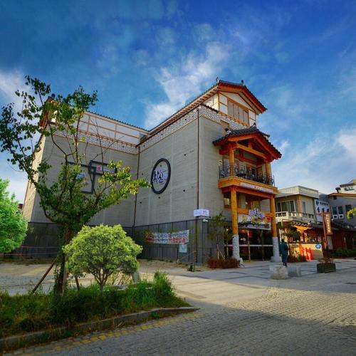 a building with a clock on the side of it at Hwangsil Tourist Hotel Seojoong in Jeonju