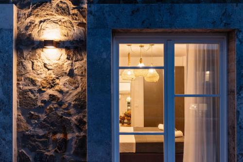 a window in a room with a blue wall at Corte Francigena - Apartments in Montalcino