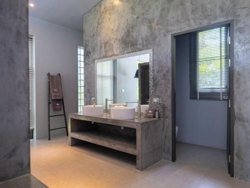 a bathroom with two sinks and a large mirror at 3Br Villa Yin Kuo Private Pool Walk to Beach in Mae Nam