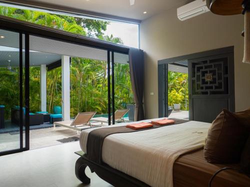 a bedroom with a bed and a large window at 3Br Villa Yin Kuo Private Pool Walk to Beach in Mae Nam