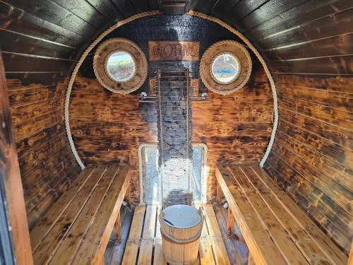 an inside view of a wooden cabin with two windows at Cicha Polana in Szczyrk