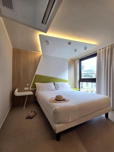 a bedroom with a bed with a hat on it at Cristal Hotel Palermo in Palermo