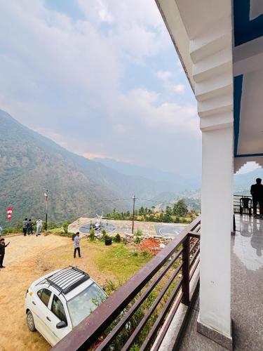 a car parked on the side of a balcony at R K Hotel & HELY ROOMS in Phata